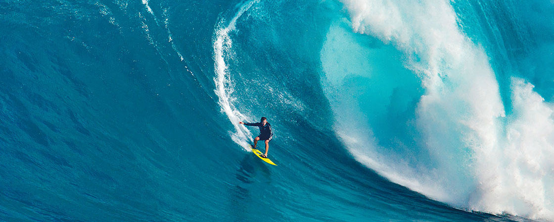 a surfer riding a huge wave