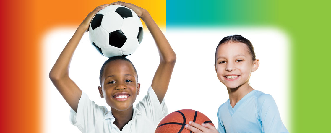 a boy holding a basketball next to a girl holding a soccer ball