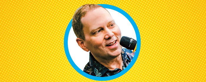 A man speaks into a microphone held close to his face